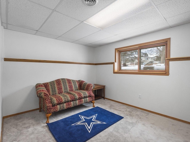 sitting room featuring a drop ceiling, carpet flooring, visible vents, and baseboards