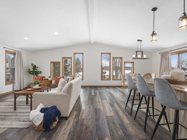 interior space featuring dark wood-type flooring, lofted ceiling with beams, and baseboards