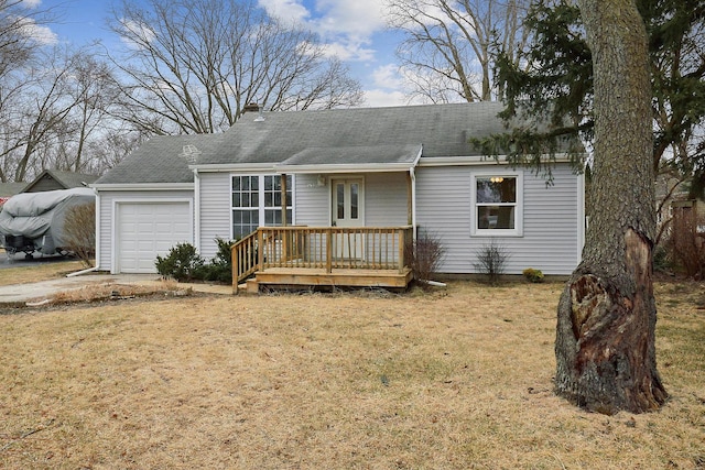 view of front of house with a garage, driveway, and a front lawn