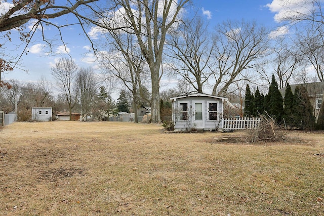 view of yard with an outbuilding and fence