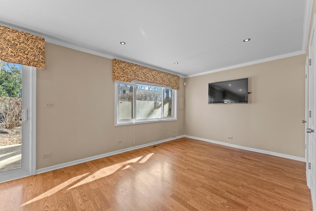 empty room with recessed lighting, crown molding, baseboards, and wood finished floors