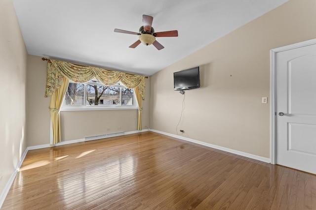 empty room featuring hardwood / wood-style floors, a ceiling fan, baseboards, a baseboard radiator, and lofted ceiling