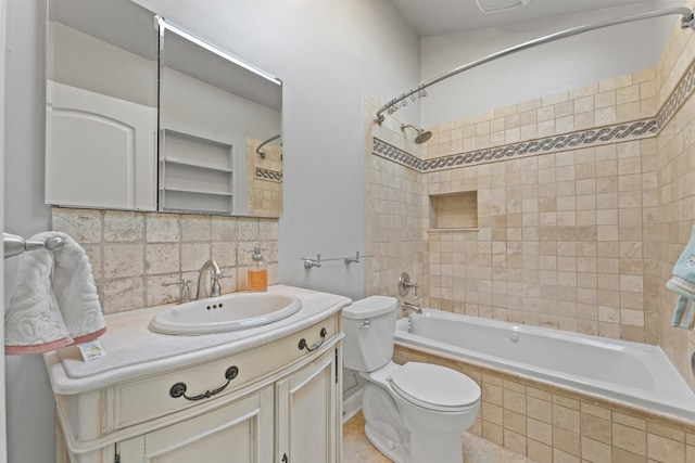 full bathroom featuring vanity, toilet, backsplash, and tiled shower / bath combo