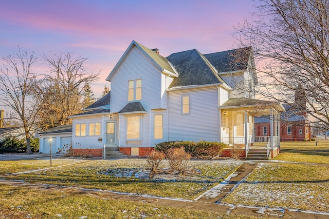 view of front of property featuring a chimney, driveway, a lawn, and an attached garage