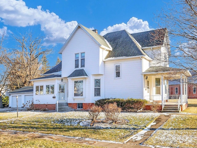 view of front of property featuring a porch, a chimney, and an attached garage