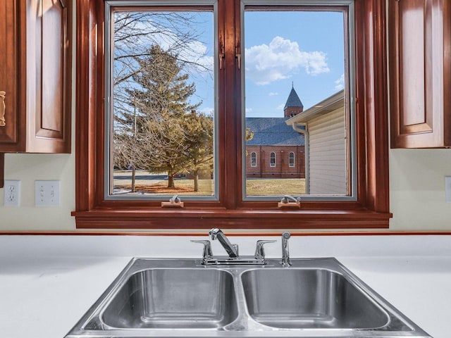 interior details with light countertops and a sink