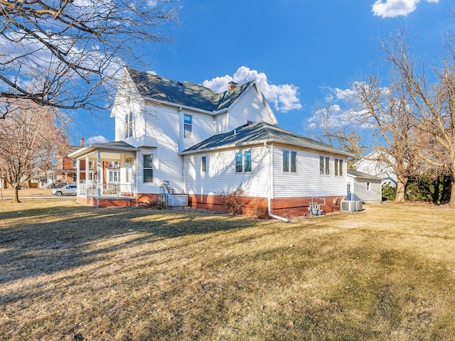 view of side of property with central air condition unit, a porch, and a lawn