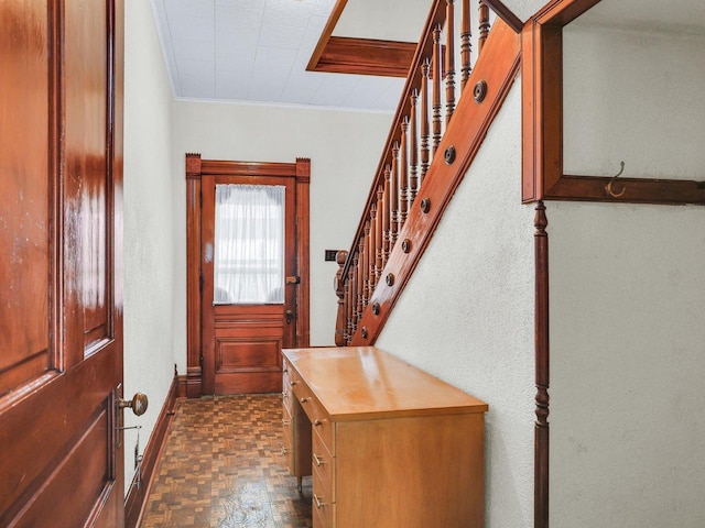 doorway to outside with baseboards, stairway, and crown molding