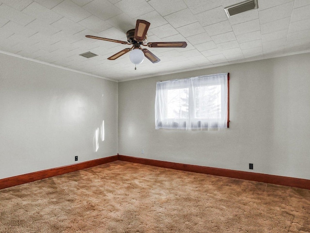 unfurnished room featuring baseboards, visible vents, carpet flooring, and ornamental molding