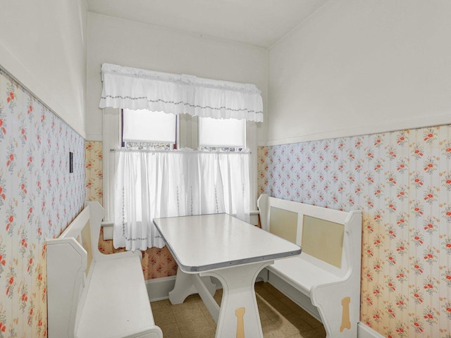 dining area featuring wallpapered walls