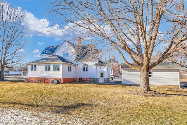 view of front of home featuring central AC, a chimney, and a front yard