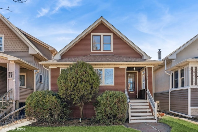 bungalow-style home with a shingled roof