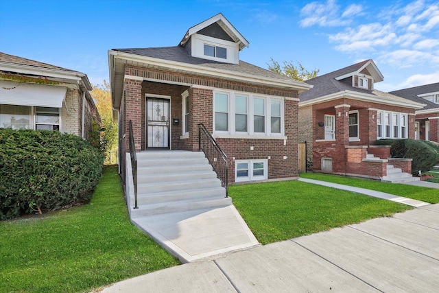 bungalow with a front lawn and brick siding