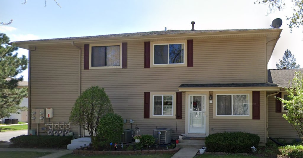 view of front of house with entry steps and central AC