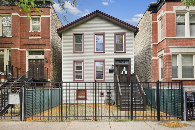 view of property with a fenced front yard and a gate