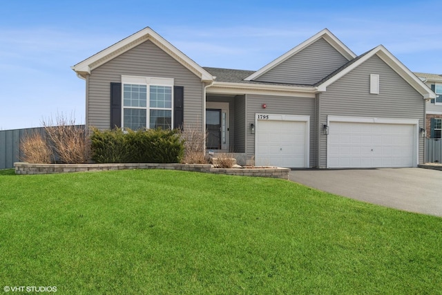 ranch-style house with aphalt driveway, an attached garage, and a front lawn