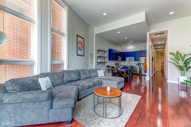 living room featuring dark wood-style floors, a wealth of natural light, and recessed lighting