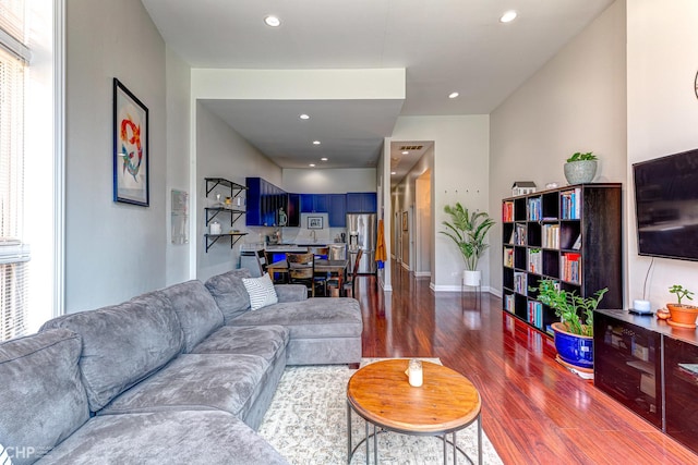 living room featuring recessed lighting and dark wood-style flooring