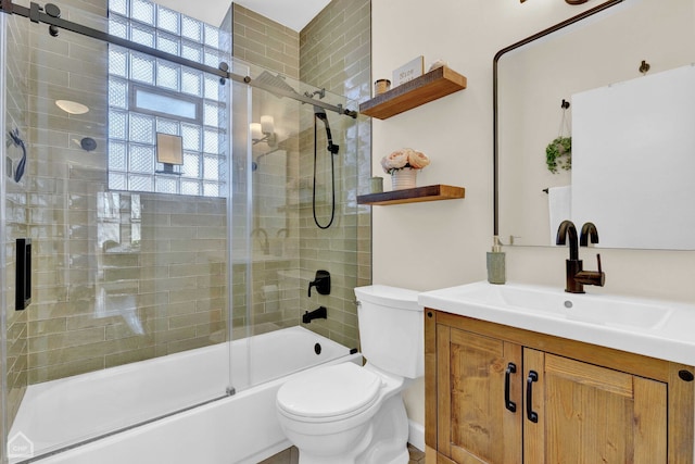 bathroom featuring vanity, toilet, and bath / shower combo with glass door