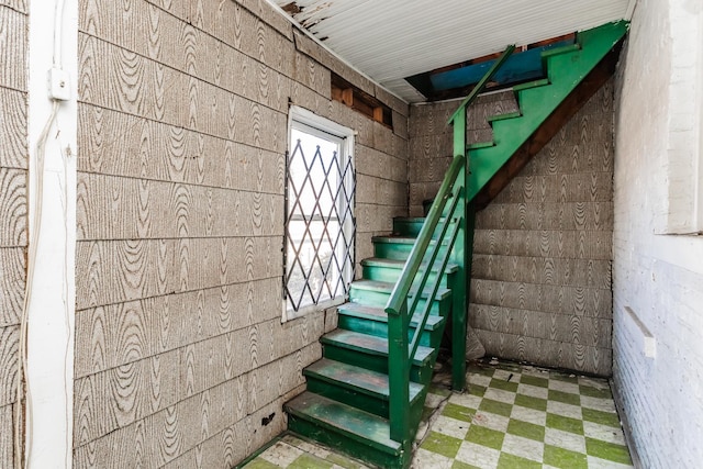 below grade area featuring stairway and tile patterned floors