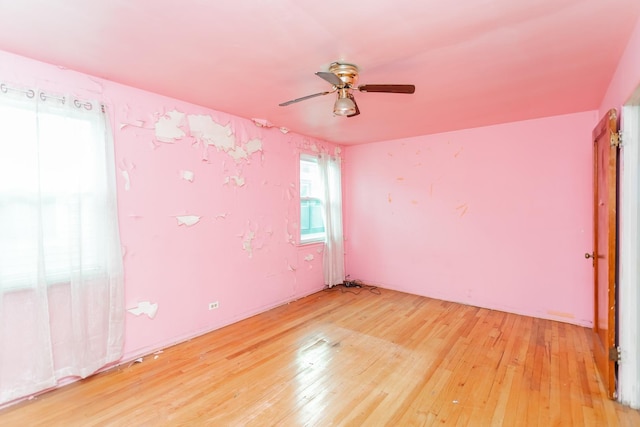 empty room featuring light wood-type flooring and ceiling fan