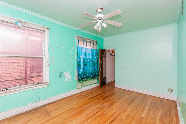 unfurnished room featuring light wood-type flooring, crown molding, and baseboards