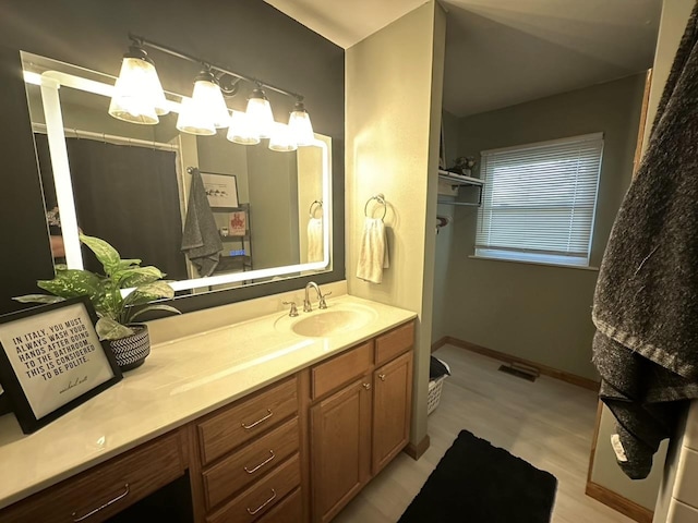 full bathroom with visible vents, baseboards, and vanity