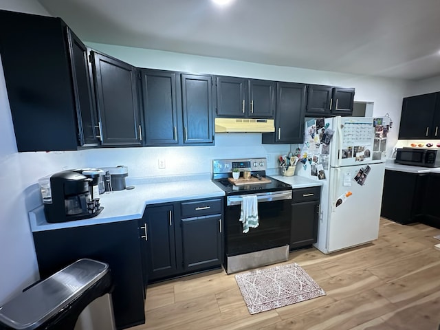 kitchen with light countertops, freestanding refrigerator, stainless steel range with electric cooktop, dark cabinetry, and under cabinet range hood