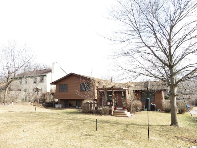 rear view of house featuring a lawn