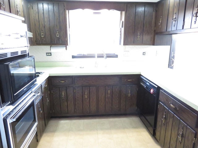 kitchen with black dishwasher, light countertops, wall oven, dark brown cabinetry, and a sink