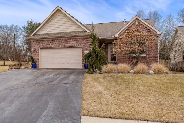 ranch-style house with brick siding, a shingled roof, aphalt driveway, an attached garage, and a front yard