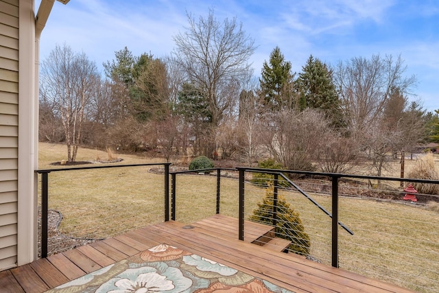 wooden terrace featuring a lawn