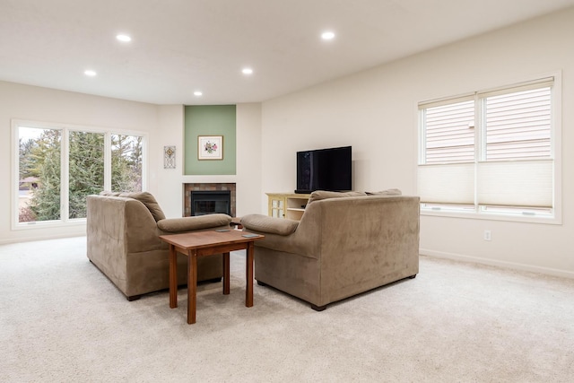 living area featuring light carpet, a tiled fireplace, baseboards, and recessed lighting