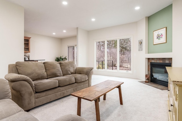 living area featuring recessed lighting, a fireplace, and carpet