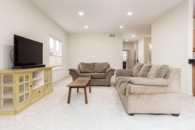 living room featuring baseboards, light colored carpet, visible vents, and recessed lighting