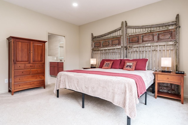 bedroom with recessed lighting, light colored carpet, and connected bathroom