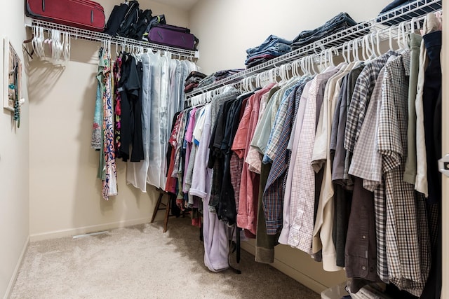 walk in closet with carpet