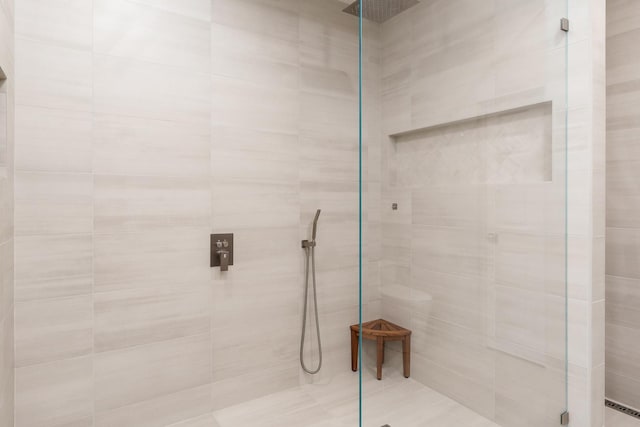 bathroom featuring a baseboard heating unit and a shower stall