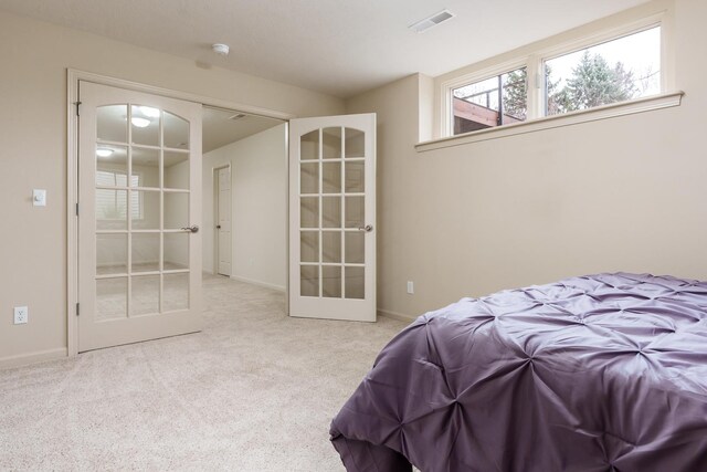 bedroom with french doors, visible vents, baseboards, and carpet flooring