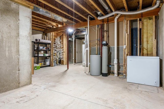 unfinished basement with fridge