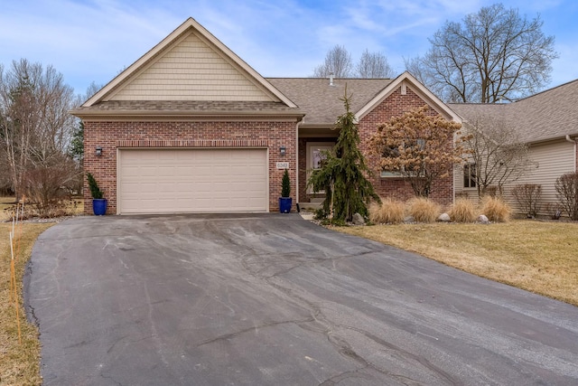 ranch-style house featuring driveway, a shingled roof, a garage, and brick siding