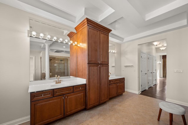 full bathroom with two vanities, a stall shower, a sink, tile patterned flooring, and baseboards