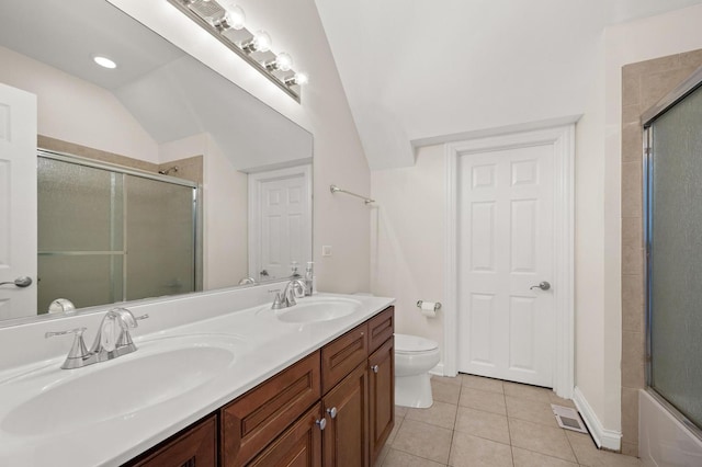 full bath with double vanity, tile patterned flooring, a sink, and toilet