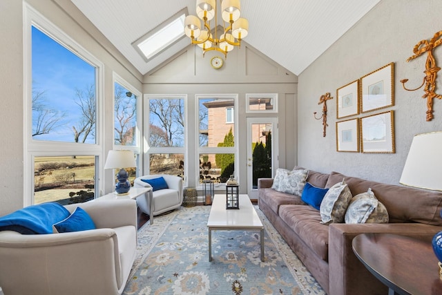 interior space featuring lofted ceiling with skylight and a notable chandelier