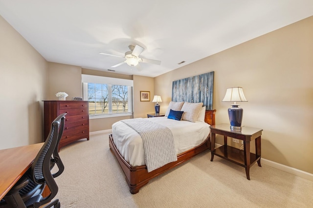 bedroom featuring baseboards, light carpet, visible vents, and a ceiling fan