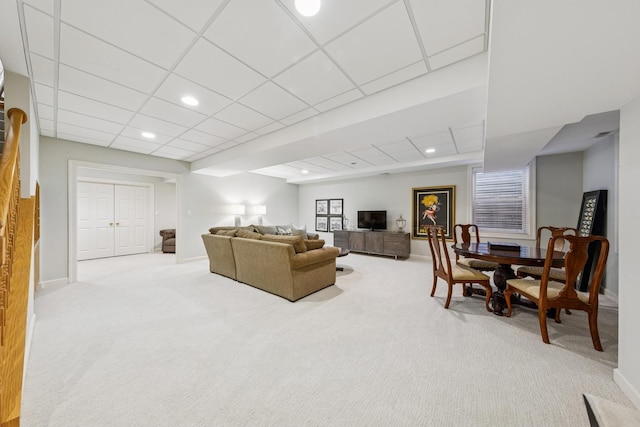 living room with carpet flooring, recessed lighting, baseboards, and a drop ceiling