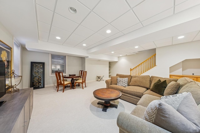 living room with stairway, recessed lighting, light colored carpet, and baseboards