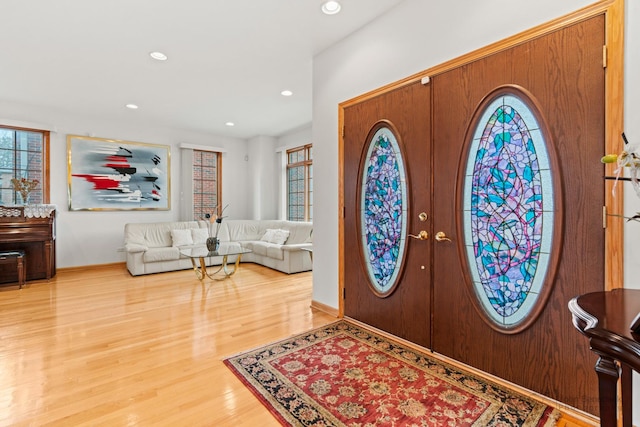 foyer entrance featuring french doors, wood finished floors, a wealth of natural light, and recessed lighting