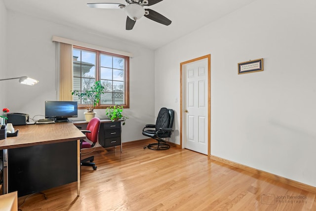 office space featuring a ceiling fan, light wood-style flooring, and baseboards