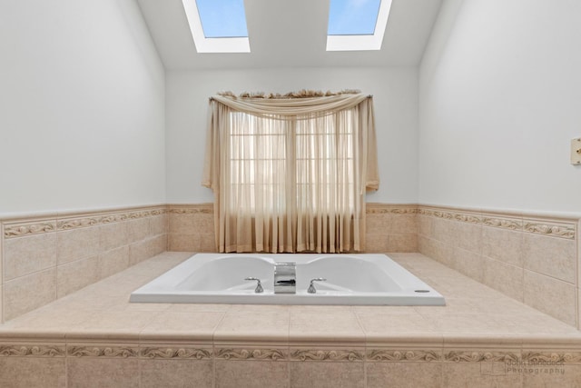 bathroom with lofted ceiling and a garden tub